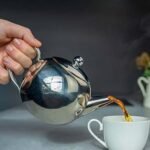 The tea jug or teapot represents the familiar ritual of preparing and sharing chai Chai Kasarod tea brand logo designed by Logoraj